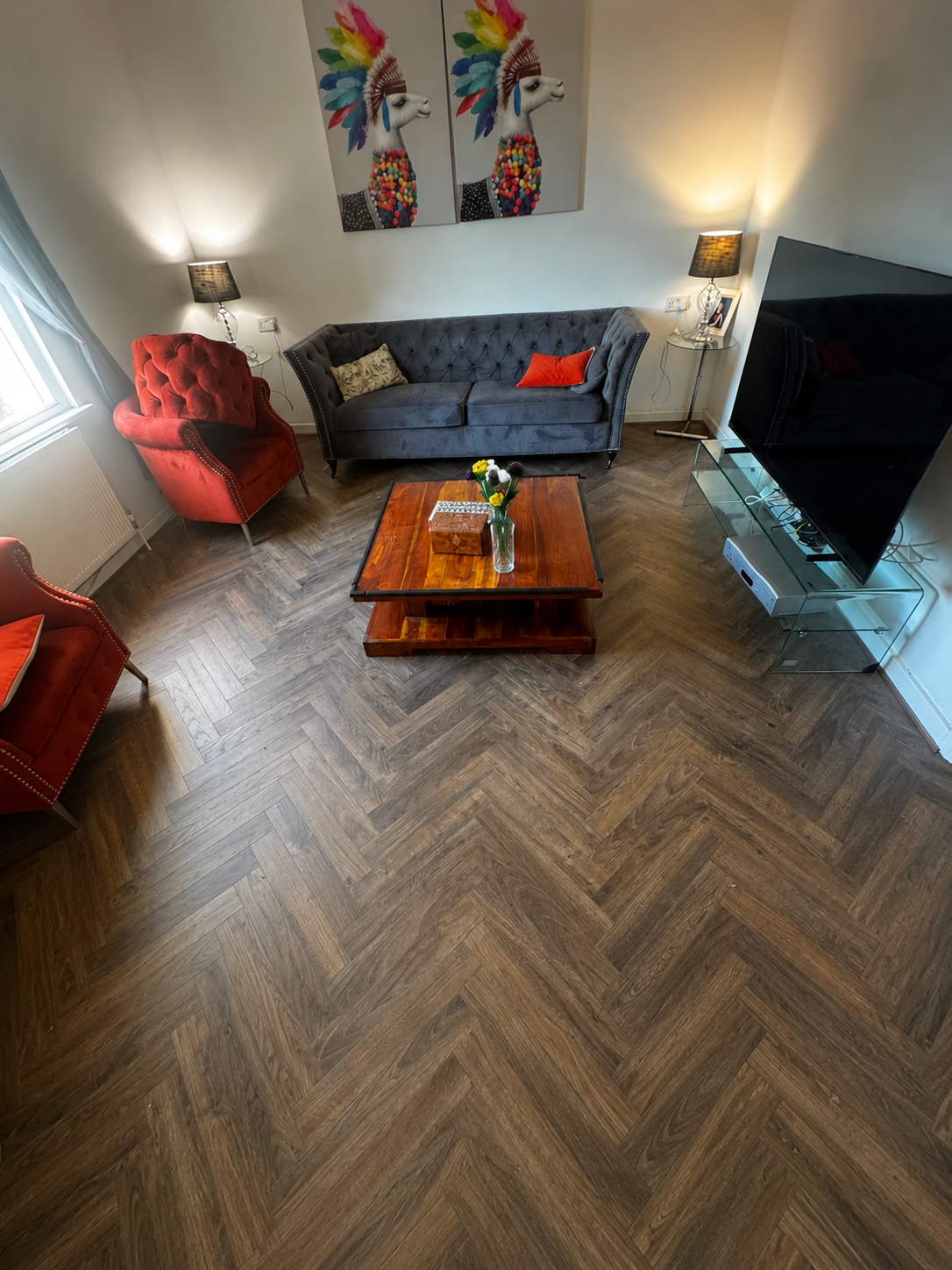 Dark oak herringbone LVT floor in a family reception room