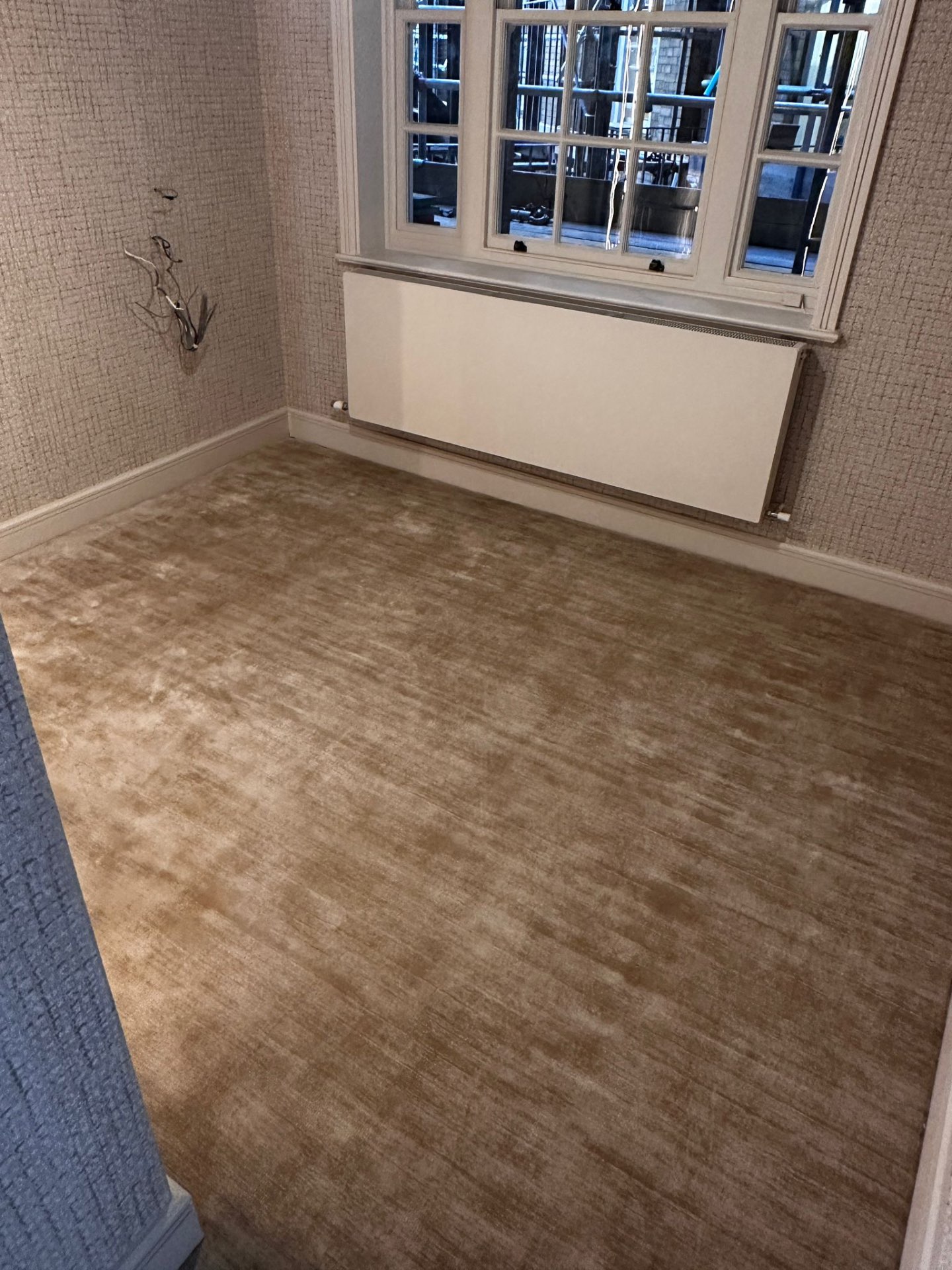 Champagne silk-look carpet fitted by The Waldorf Carpets in a London bedroom