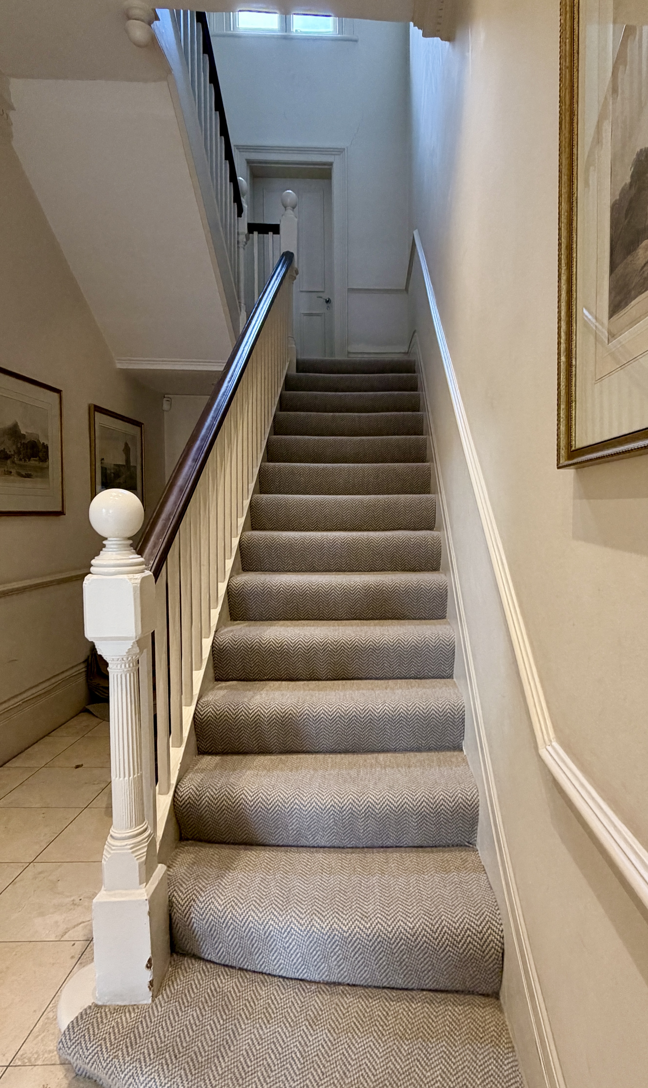 Soft grey herringbone stair carpet fitted on a period staircase in west London